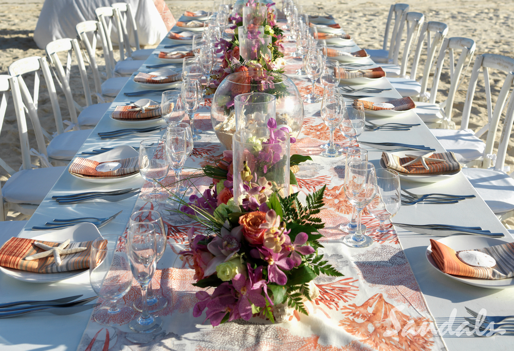 wedding reception table with peach and white accents, flowers and decor