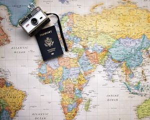 Passport and camera on a world map.